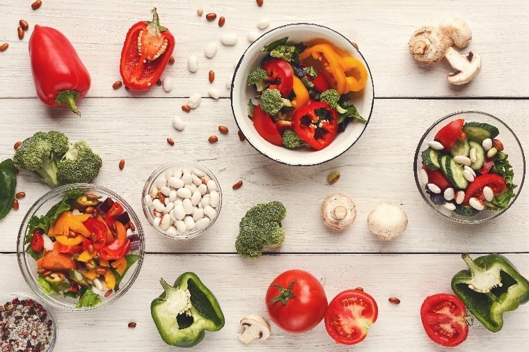 Various salad bowls on white wooden table